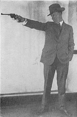 Dr John L Bastey firing revolver
